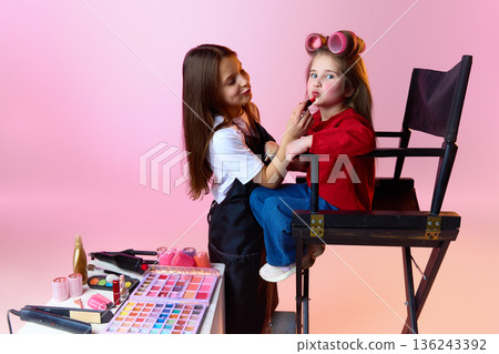 Children role playing makeup artist and model in studio. Children role playing makeup artist and model in studio. 136243392