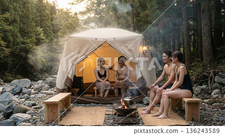 A man and woman enjoying a tent sauna 136243589