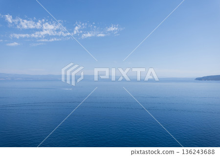 Calm Adriatic Sea view in Croatia with clear blue sky, gentle waves, and distant coastline, creating a peaceful summer seascape. Beautiful sea view with blue sky and islands. Summer vacation 136243688