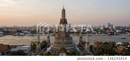 Aerial wide angle view of Wat Arun temple overlooking Bangkok city and Chao Phraya River at golden hour 136243814