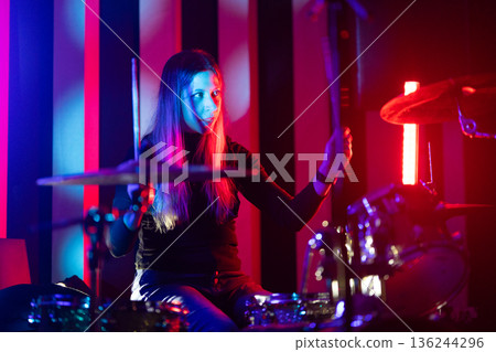 Woman drummer performing live music on stage Woman drummer performing live music on stage 136244296