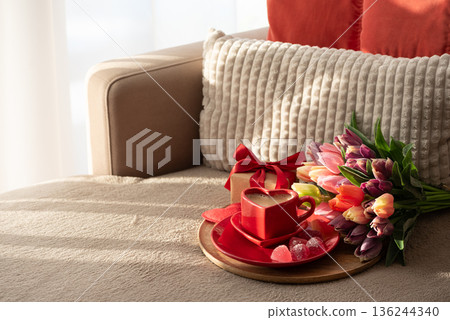 Heart Shaped Coffee Cup with Colorful Tulips and Candies. Cozy Romantic Flatlay on Sofa for Valentines Day Celebration Heart Shaped Coffee Cup with Colorful Tulips and Candies. Cozy Romantic Flatlay on Sofa for Valentines Day Celebration 136244340
