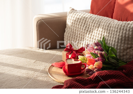 Top View Heart Shaped Coffee Cup with Colorful Tulips and Candies. Cozy Romantic Flatlay on Sofa for Valentines Day Celebration 136244343