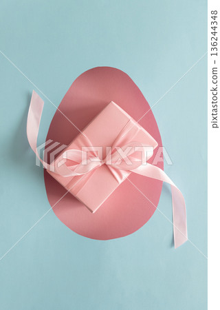 Easter Gift Box in Heart Cutout. Festive Spring Flatlay on Blue Background Easter Gift Box in Heart Cutout. Festive Spring Flatlay on Blue Background 136244348