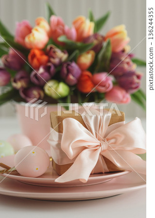 Easter Table Setting with Gift Box, Decorated Eggs and Tulips. Festive Spring Lifestyle Easter Table Setting with Gift Box, Decorated Eggs and Tulips. Festive Spring Lifestyle 136244355