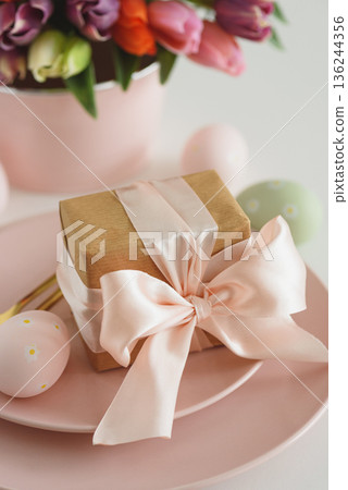 Easter Table Setting with Gift Box, Decorated Eggs and Tulips. Festive Spring Lifestyle Easter Table Setting with Gift Box, Decorated Eggs and Tulips. Festive Spring Lifestyle 136244356