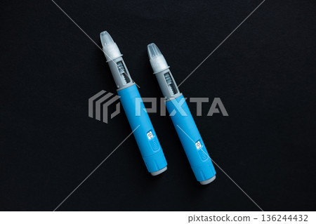 Ozempic insulin pen. Blue medical drug anti diabetes injector. Concept of diet, glucose control, health risks, and obesity prevention. Ozempic insulin pen. Blue medical drug anti diabetes injector. Concept of diet, glucose control, health risks, and obesity prevention. 136244432