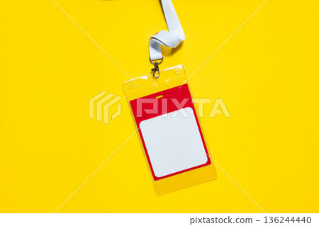 ID badge with lanyard on yellow background. Simple design with space for name or info, symbolizing identity, access, business meetings, or staff registration. Free copy space for design 136244440