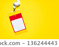 Minimalist name badge with copy space, suspended by a white lanyard. Red and yellow accents on a yellow backdrop. Perfect for conference, event, or office ID visuals 136244443