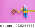 Concept image of diabetes and obesity treatment with two insulin pens and a measuring tape on pastel background. drugs injection ozempic for weight loss 136244444