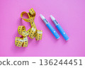 Two blue insulin pens and a yellow measuring tape on a pink background, symbolizing weight loss, diabetes treatment, and medical control. drugs injection ozempic for weight loss 136244451