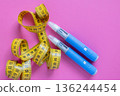 Flat lay of insulin pens and yellow tape measure. Concept image for health monitoring, diabetes control, and weight loss solutions. drugs injection ozempic for weight loss 136244454