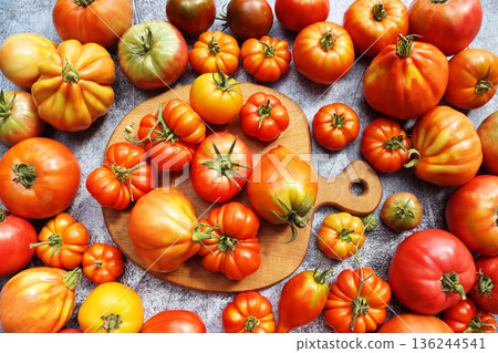 Vibrant Heirloom Tomatoes Harvested on a Rustic Surface	 136244541