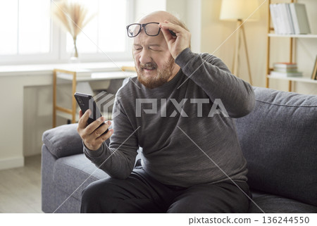 Elderly Man With Smartphone Struggling With Eyesight Elderly Man With Smartphone Struggling With Eyesight 136244550
