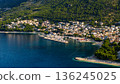 Aerial view of Baska Voda marina with yachts turquoise Adriatic Sea pine covered hills Dalmatian coast Croatia 136245025