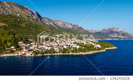 Aerial view of Croatian seaside town with red roofs and rocky coastline on Adriatic Sea Aerial view of Croatian seaside town with red roofs and rocky coastline on Adriatic Sea 136245026