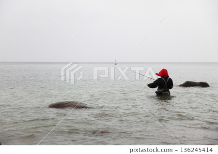 Fisherman in sea water autumn 136245414