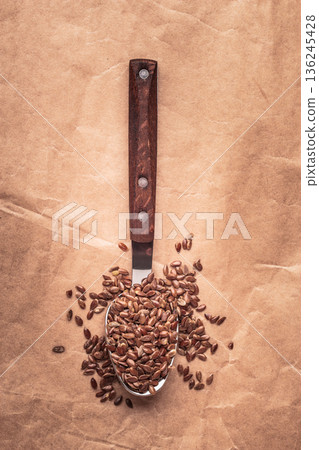 Flax seeds linseed on kitchen spoon 136245428