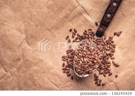 Flax seeds linseed on kitchen spoon Flax seeds linseed on kitchen spoon 136245429