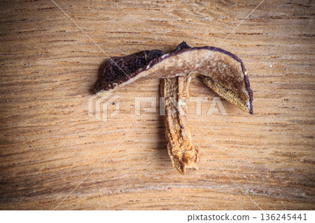 Dry mushroom boletus on wooden table. 136245441