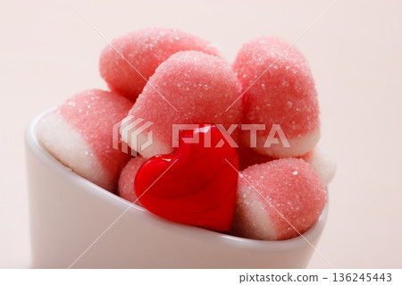 Pink jellies or marshmallows with sugar in bowl Pink jellies or marshmallows with sugar in bowl 136245443