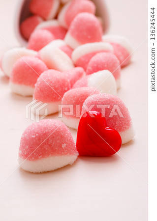 Pink jellies or marshmallows with sugar on table Pink jellies or marshmallows with sugar on table 136245444