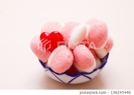 Pink jellies or marshmallows with sugar in bowl Pink jellies or marshmallows with sugar in bowl 136245446