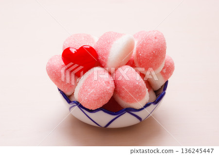 Pink jellies or marshmallows with sugar in bowl Pink jellies or marshmallows with sugar in bowl 136245447
