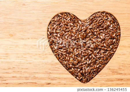 Raw flax seeds linseed heart shaped Raw flax seeds linseed heart shaped 136245455
