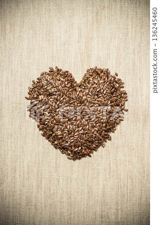 Raw flax seeds linseed heart shaped Raw flax seeds linseed heart shaped 136245460
