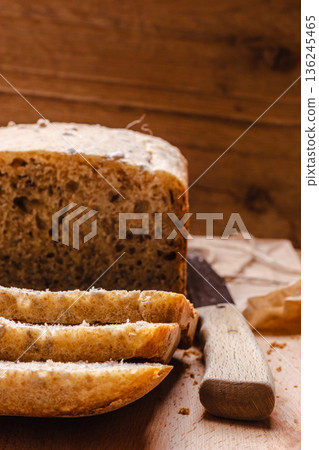 Sliced whole wheat bread on cutting board Sliced whole wheat bread on cutting board 136245465