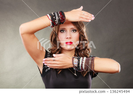 woman with jewellery in black evening dress 136245494