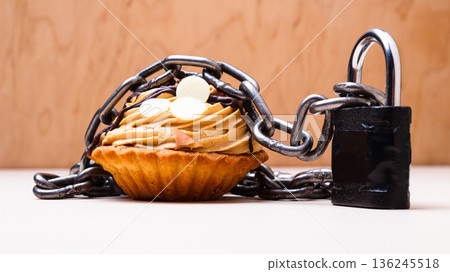 Cake with chain and padlock, diet concept. Cake with chain and padlock, diet concept. 136245518