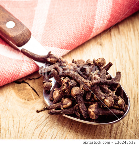 Spice cloves on kitchen spoon Spice cloves on kitchen spoon 136245532
