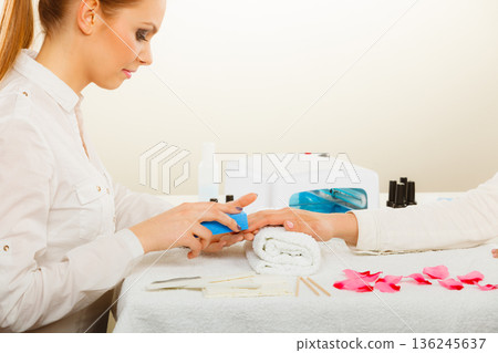 Woman getting manicure done file nails Woman getting manicure done file nails 136245637