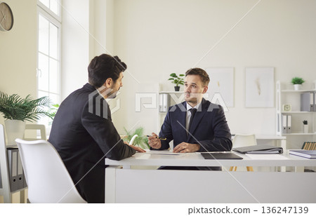 Business People Working Together With Documents During Negotiation In Office Business People Working Together With Documents During Negotiation In Office 136247139