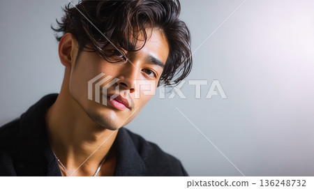 Young Asian man with styled hair looking at camera Young Asian man with styled hair looking at camera 136248732