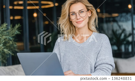 Young woman with glasses using laptop 136248831