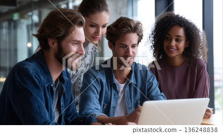 Young professionals collaborating on laptop 136248838