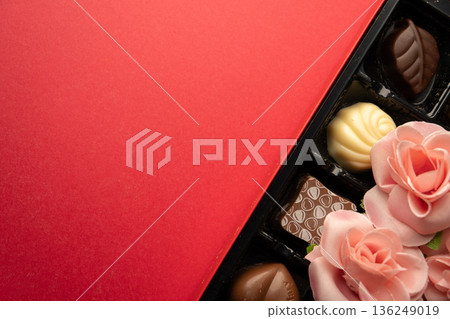 A photo combining decorative flowers and chocolate candy A photo combining decorative flowers and chocolate candy 136249019