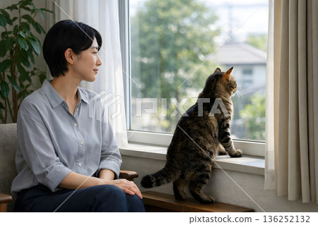 Quiet time watching the cat looking out the window 136252132