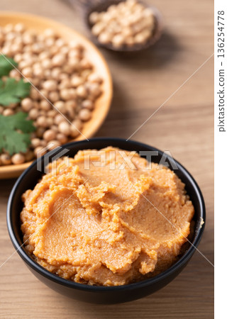 Traditional Japanese miso paste in a black bowl. Healthy fermented soybean seasoning for cooking Traditional Japanese miso paste in a black bowl. Healthy fermented soybean seasoning for cooking 136254778