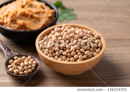 Raw organic soybeans and miso paste on a rustic wooden table, healthy plant-based protein source Raw organic soybeans and miso paste on a rustic wooden table, healthy plant-based protein source 136254781