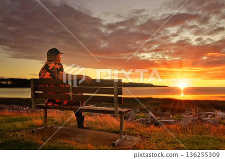Man Sitting Watching A Wonderful Summer Sunset Foxton Beach New Zealand Man Sitting Watching A Wonderful Summer Sunset Foxton Beach New Zealand 136255309