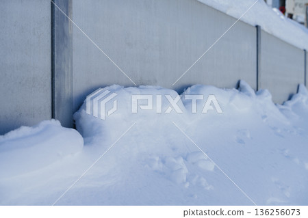 Snow clinging to the wall Snow clinging to the wall 136256073