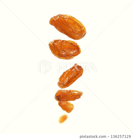 A stunning display of dried raisins elegantly arranged on a light and bright background 136257129
