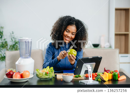 Joyful woman in kitchen making colorful, healthy meals with fresh vegetables, fruits, and a blender, embracing wellness and clean eating at home. Joyful woman in kitchen making colorful, healthy meals with fresh vegetables, fruits, and a blender, embracing wellness and clean eating at home. 136257256