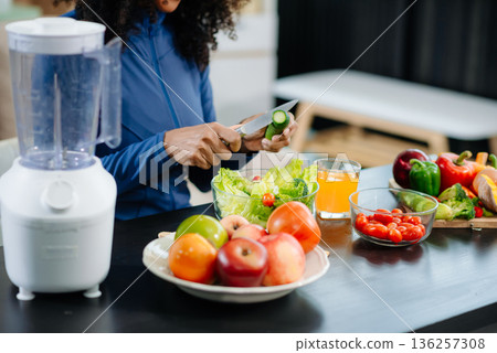 Healthy cooking, featuring fresh fruits, vegetables, and a blender. Perfect for themes of nutrition, wellness Healthy cooking, featuring fresh fruits, vegetables, and a blender. Perfect for themes of nutrition, wellness 136257308
