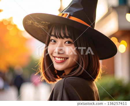 A young woman in a witch (wizard) costume for Halloween 136257411