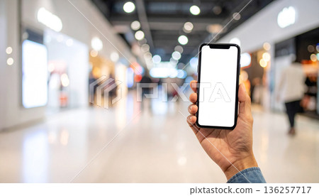Man Holding Smartphone in Modern Shopping Mall Man Holding Smartphone in Modern Shopping Mall 136257717